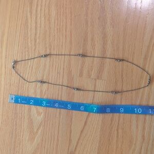 Necklace with groups of small metal beads